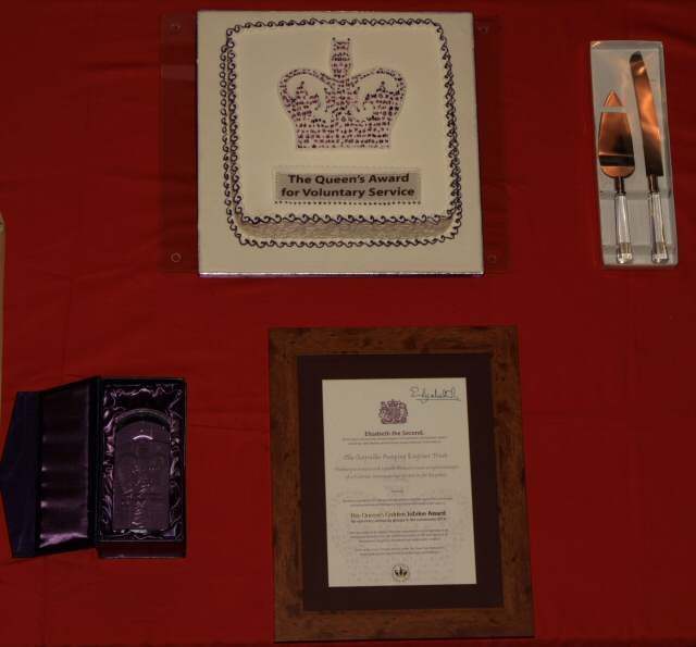 The commemorative crystal, certificate, signed by Her Majesty and the celebration cake.